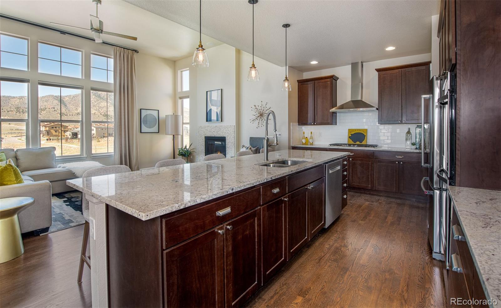2589 South Kilmer Street Lakewood, CO 80228 - Photo 11 of 40 a kitchen with lots of counter space a sink appliances and windows