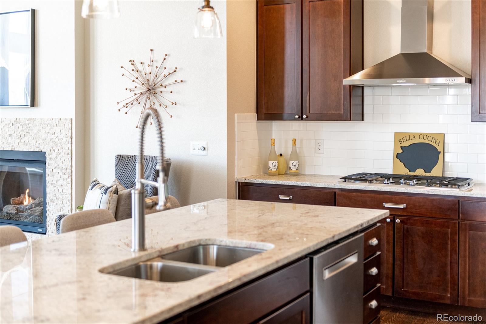 2589 South Kilmer Street Lakewood, CO 80228 - Photo 12 of 40 a kitchen with a sink and a stove