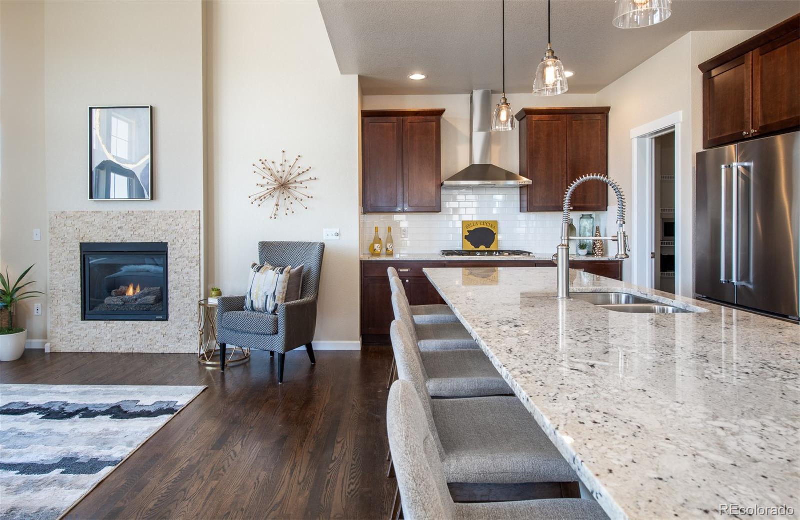2589 South Kilmer Street Lakewood, CO 80228 - Photo 13 of 40 a kitchen with stainless steel appliances granite countertop a refrigerator a stove and a wooden floors