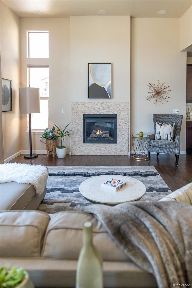 2589 South Kilmer Street Lakewood, CO 80228 - Photo 19 of 40 a living room with furniture and a fireplace