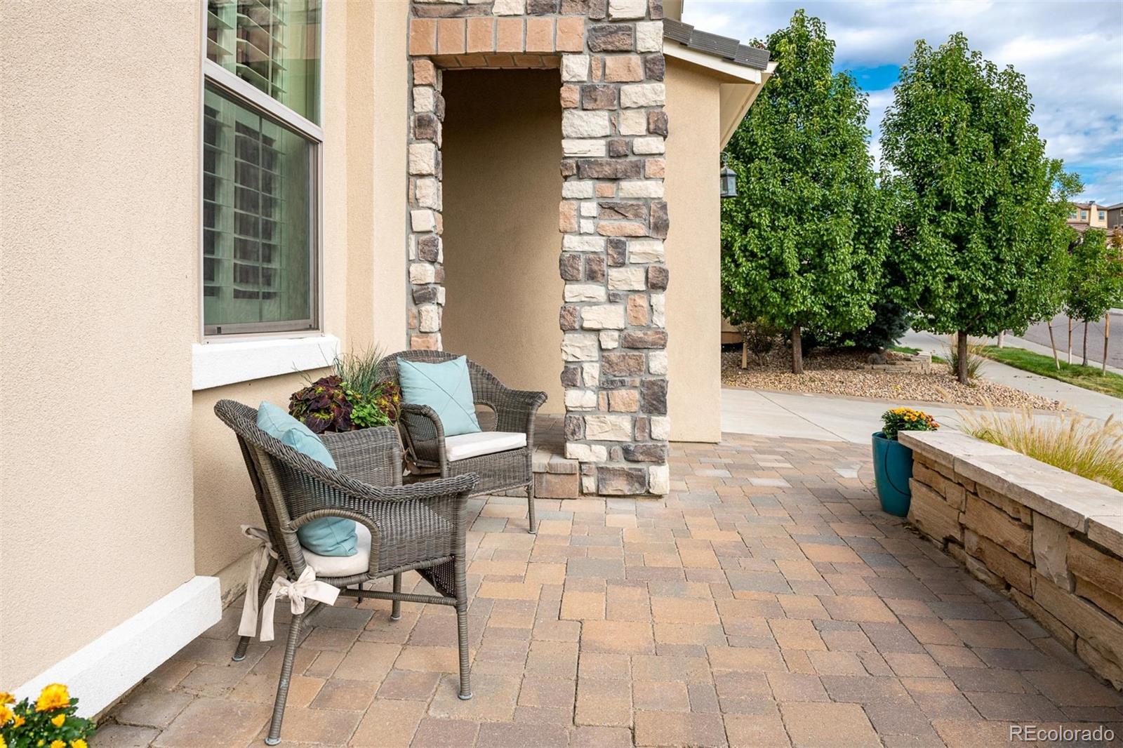 2589 South Kilmer Street Lakewood, CO 80228 - Photo 2 of 40 a view of a patio with dining table and chairs with wooden floor