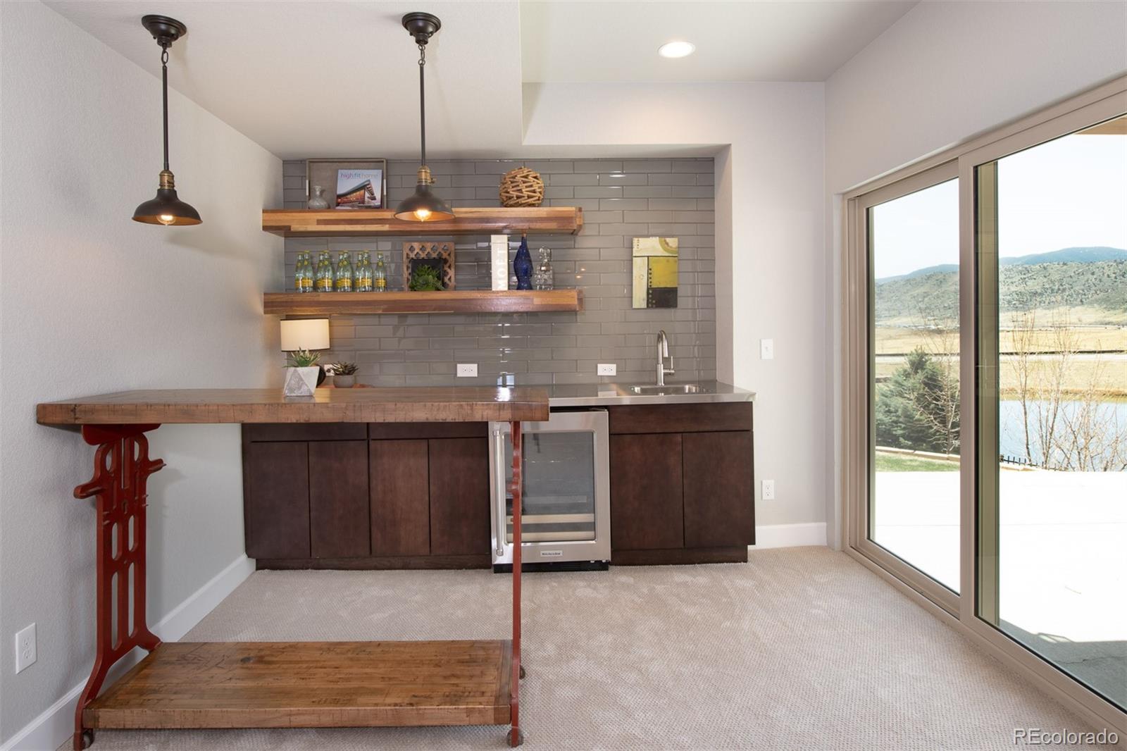 2589 South Kilmer Street Lakewood, CO 80228 - Photo 31 of 40 a kitchen with a refrigerator and a sink