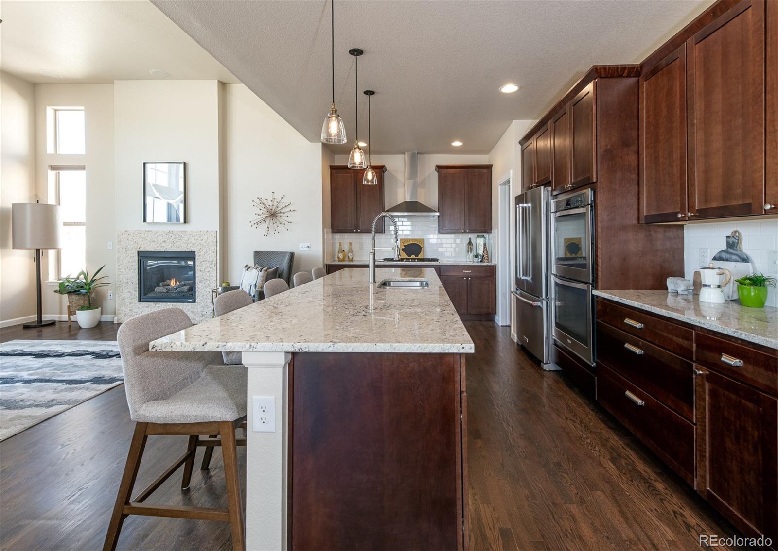 2589 South Kilmer Street Lakewood, CO 80228 - Photo 10 of 40 a kitchen with cabinets a sink oven and refrigerator