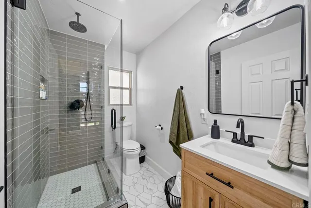 a bedroom with a bed and a glass door