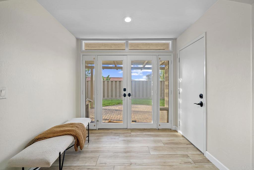 4120 Country Trails Lane Bonita, CA 91902 - Photo 14 of 26 a bedroom with a bed and a glass door