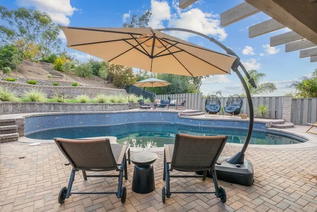 a view of swimming pool with seating space