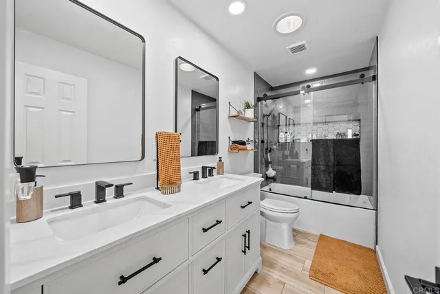a bathroom with a sink double vanity and a shower