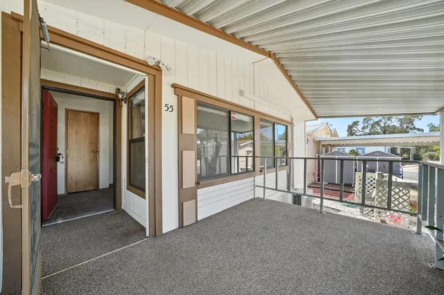 a big room with wooden floor and windows