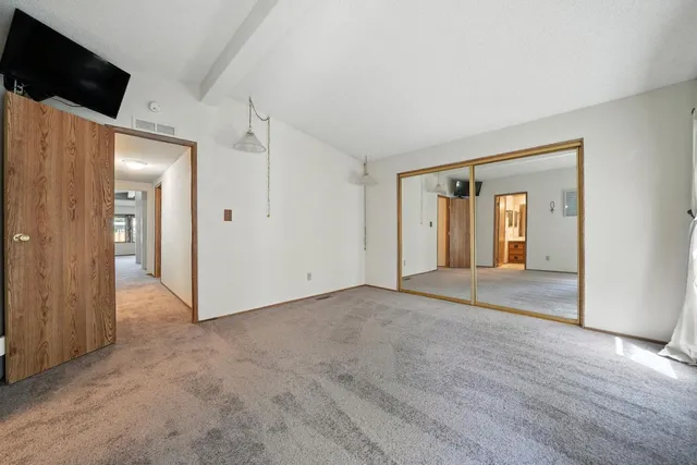 a bathroom with a sink a toilet a mirror a vanity and shower