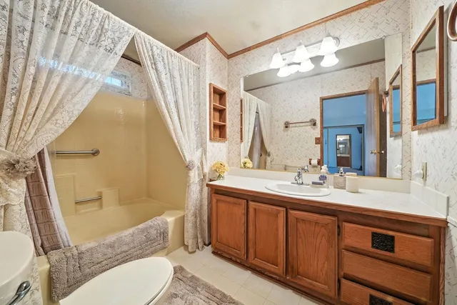 a kitchen with a refrigerator sink and cabinets