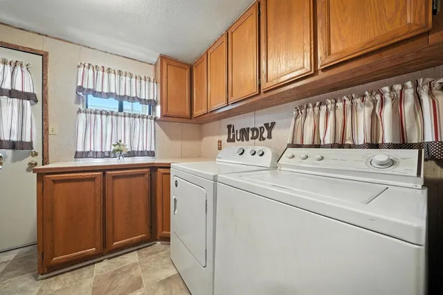 a view of a deck that has a table and chairs with wooden roof