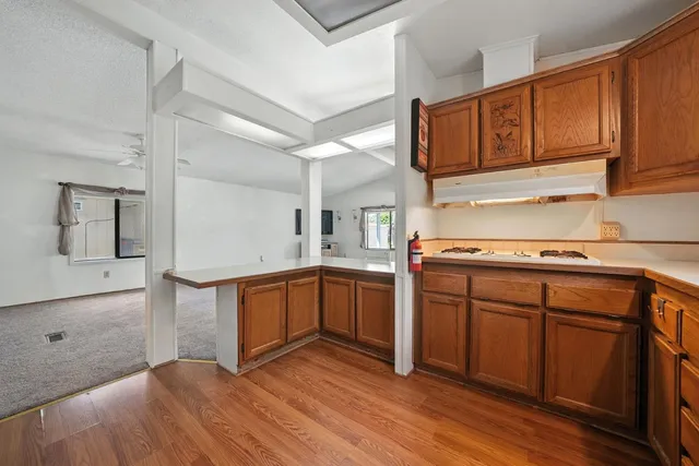 a kitchen with stainless steel appliances granite countertop a sink stove and cabinets
