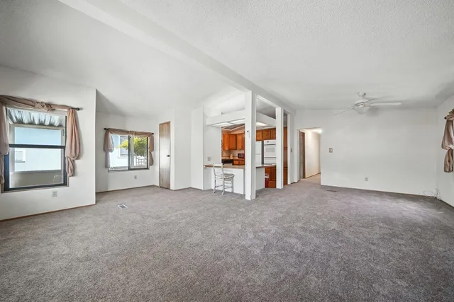 an empty room with windows and closet
