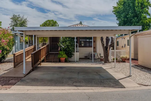 a view of a patio with table and chairs