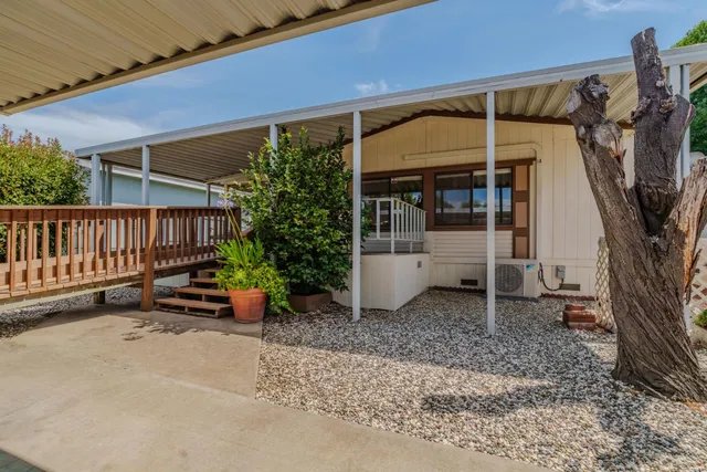 a backyard of a house with barbeque oven table and chairs