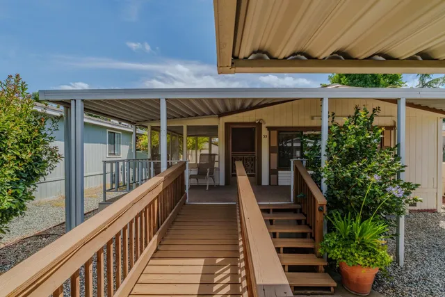 a view of a patio with table and chairs potted plants