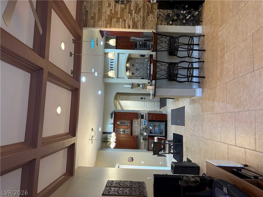 977 Rhyolite Terrace Henderson, NV 89011 - Photo 11 of 33 Exquisite coffered ceilings and tile flooring transition seamlessly into a spacious open kitchen.