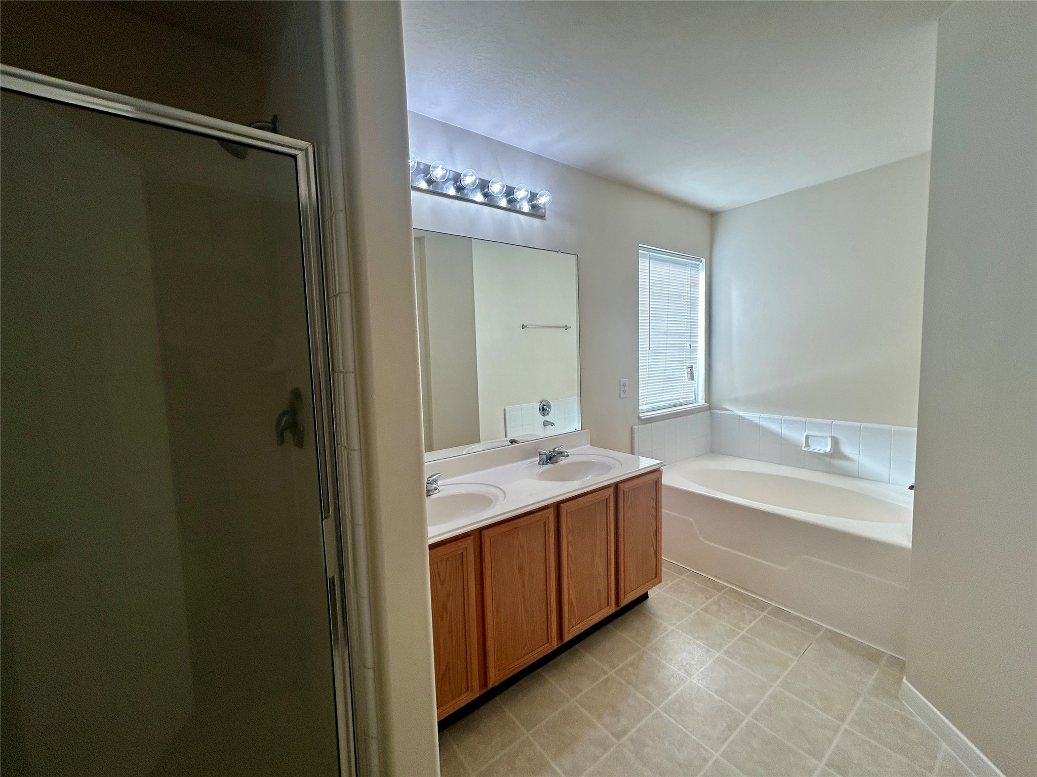 19718 River Pointe Lane Katy, TX 77449 - Photo 24 of 36 a spacious bathroom with a bathtub sink and mirror