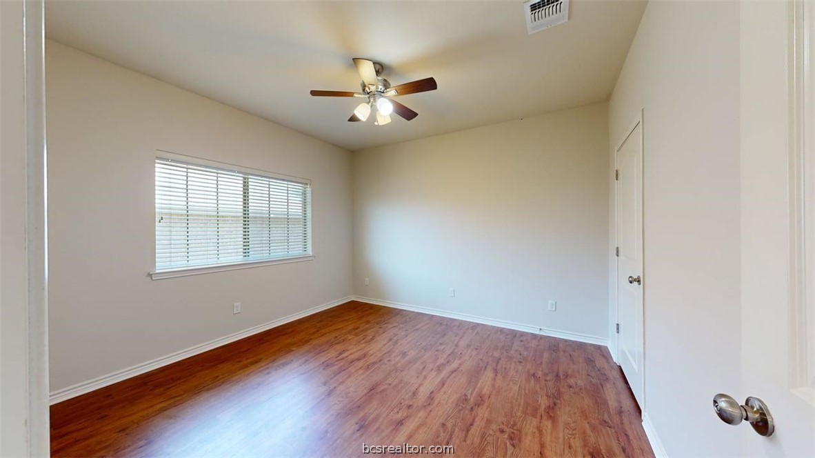 4453-4455 Reveille Road College Station, TX 77845 - Photo 15 of 37 wooden floor in an empty room with a window