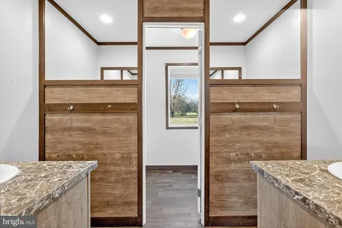 a bathroom with a granite countertop sink and shower