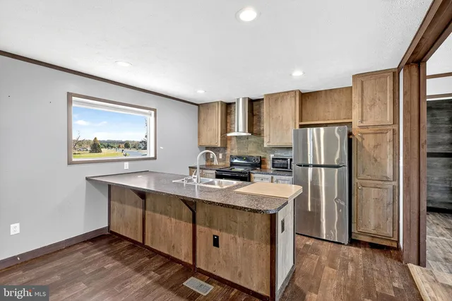 a kitchen with appliances cabinets a sink and a counter top space