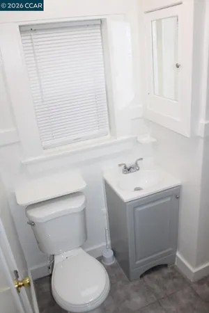 a white toilet sitting next to a bathroom sink