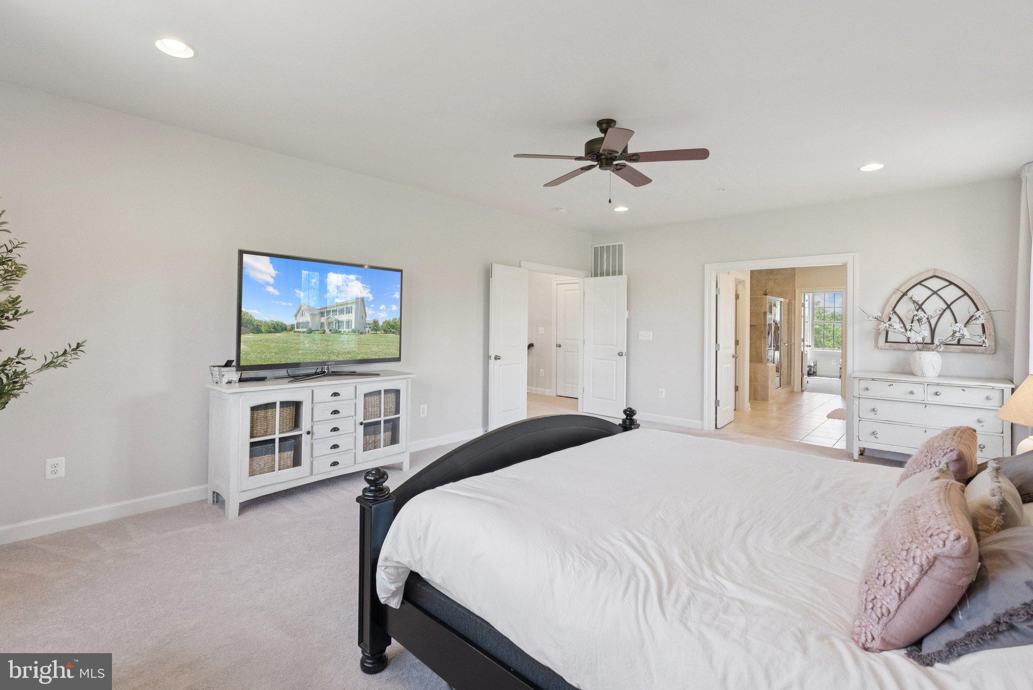 237 Barberry Lane Laytonsville, MD 20882 - Photo 30 of 70 a bedroom with a bed and a flat screen tv