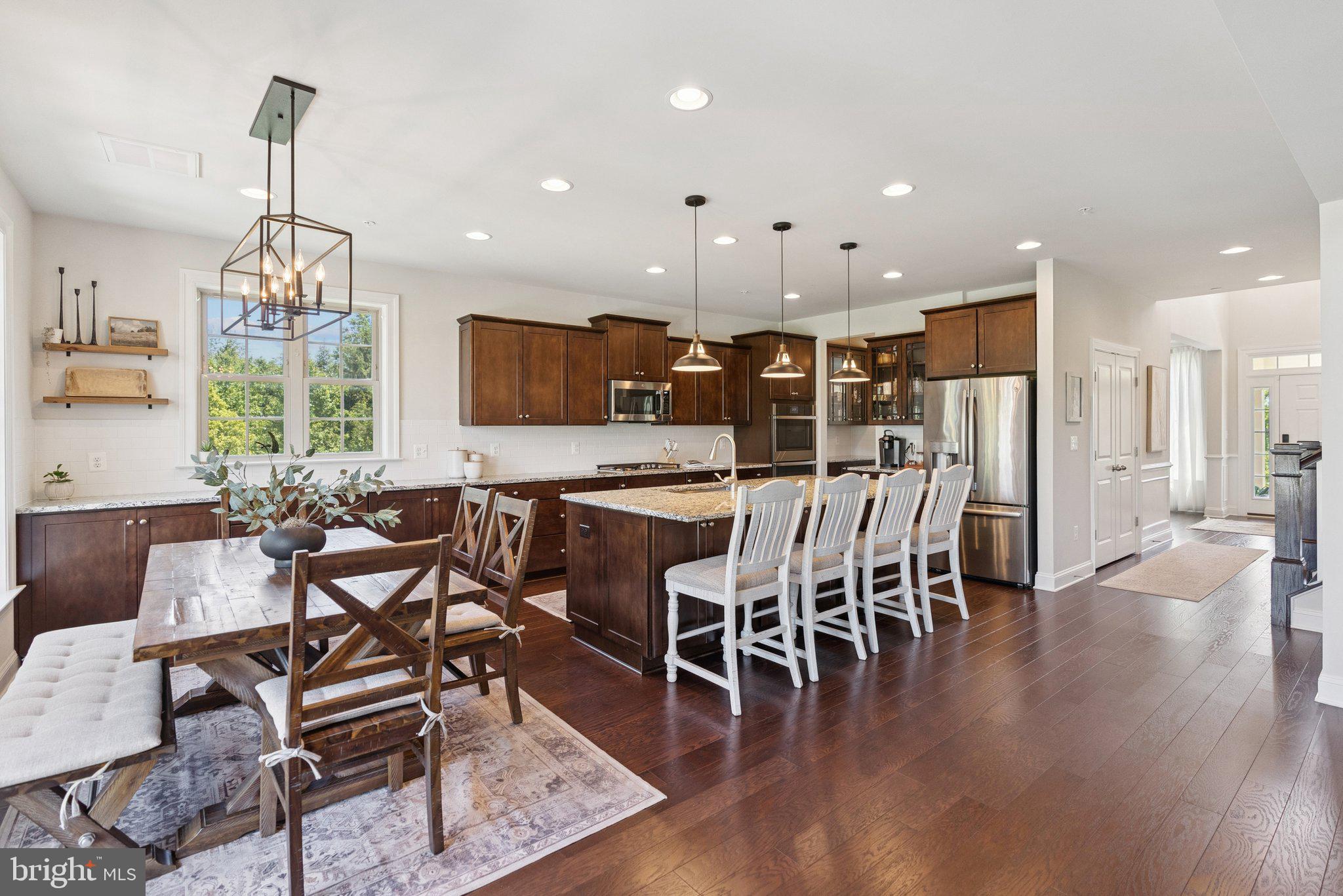 237 Barberry Lane Laytonsville, MD 20882 - Photo 69 of 70 a view of a dining room and livingroom with furniture wooden floor a chandelier
