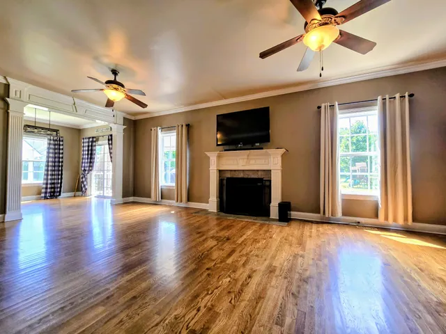 a view of entryway and hall with wooden floor