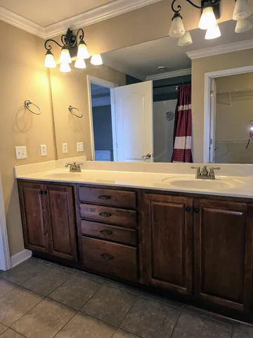 a backyard of a house with table and chairs under an umbrella