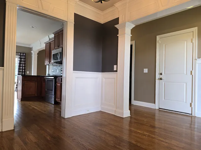 wooden floor fireplace and windows in an empty room