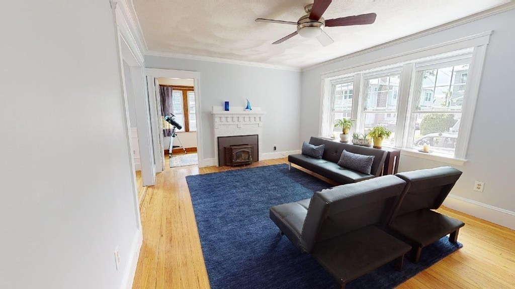 54 Chester Road, Unit 1 Belmont, MA 02478 - Photo 2 of 11 a living room with furniture and a fireplace