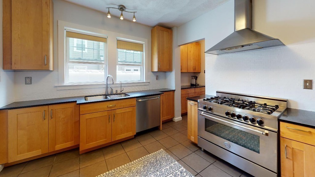 54 Chester Road, Unit 1 Belmont, MA 02478 - Photo 6 of 11 a kitchen with stainless steel appliances a stove a sink and a microwave