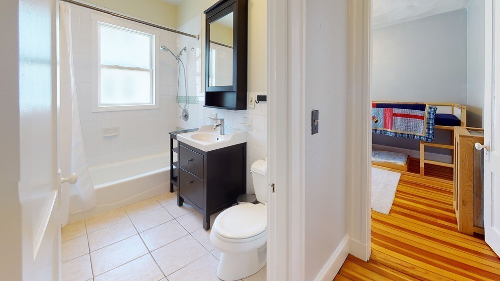 54 Chester Road, Unit 1 Belmont, MA 02478 - Photo 8 of 11 a bathroom with a toilet sink and mirror