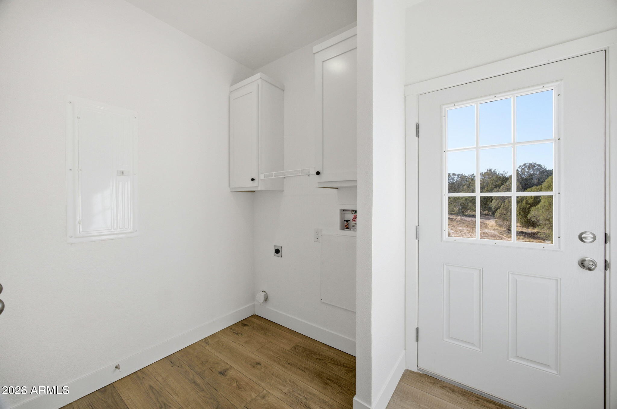 2146 Copper Road Clay Springs, AZ 85923 - Photo 21 of 30 a view of an empty room with wooden floor and a window
