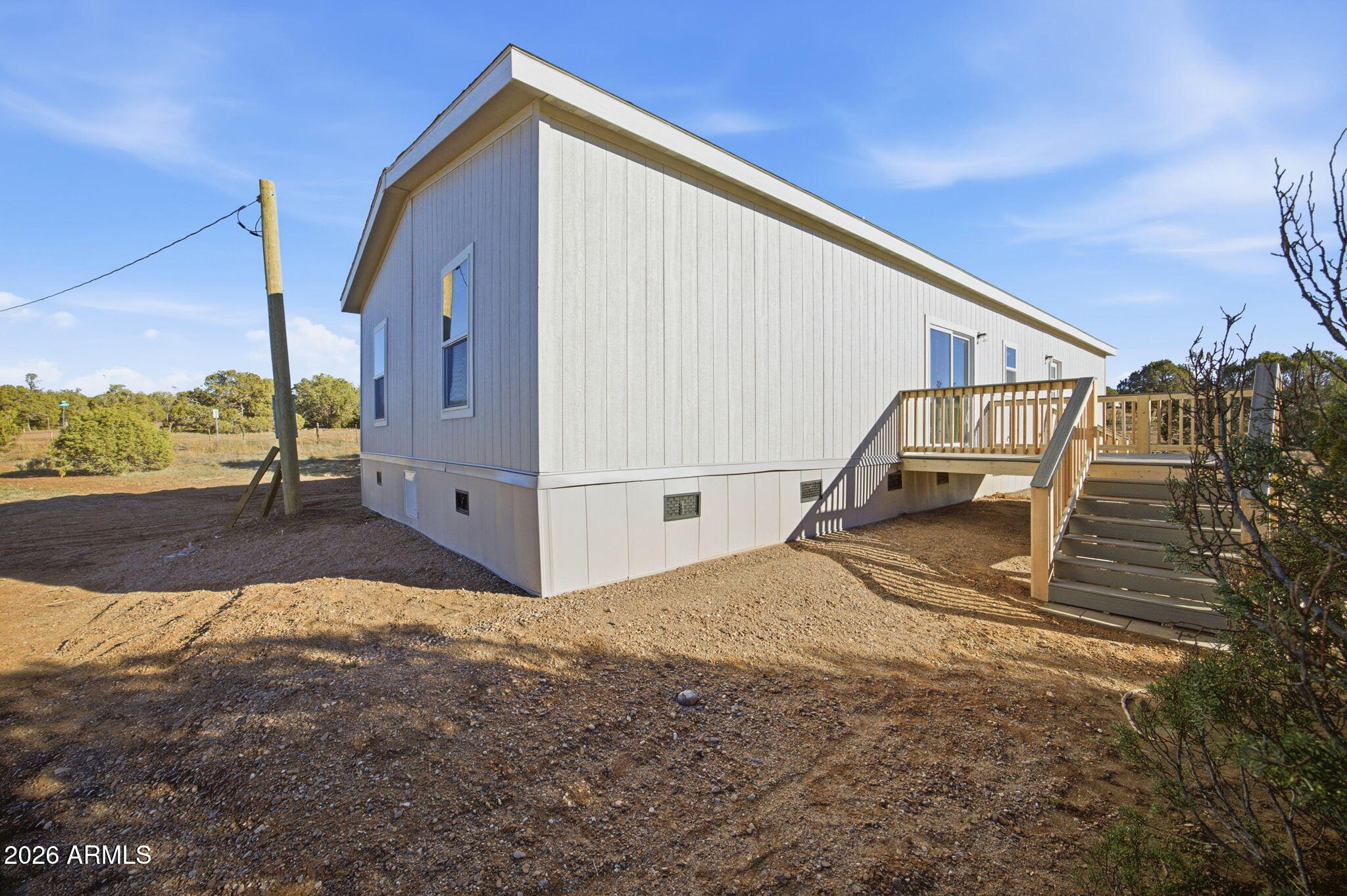 2146 Copper Road Clay Springs, AZ 85923 - Photo 24 of 30 a view of a house with backyard and deck