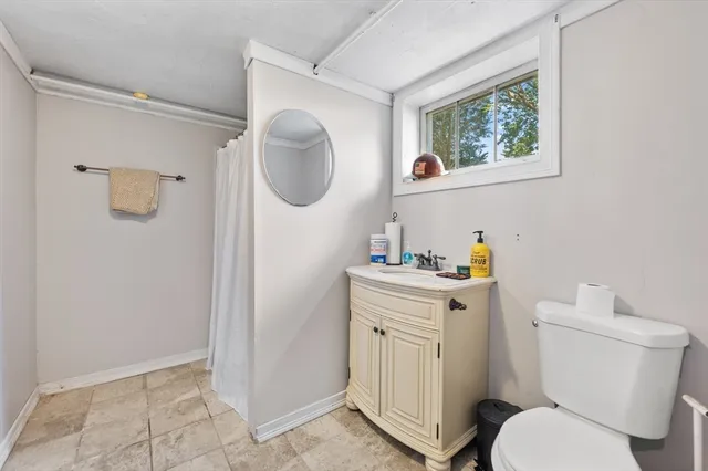 a white house with a tree in the grass