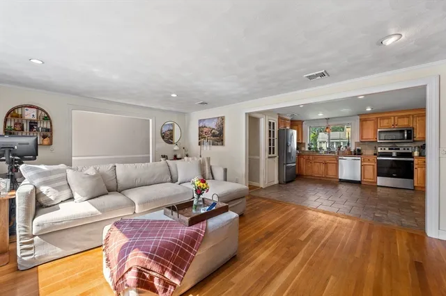a living room with furniture and kitchen view