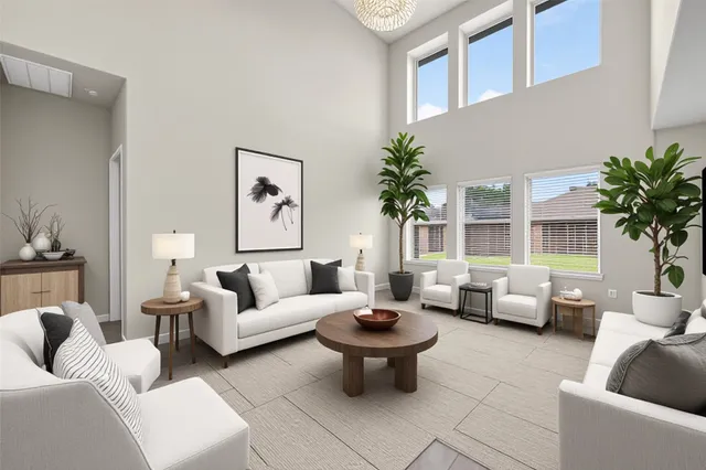 a living room with furniture a couch and a potted plant