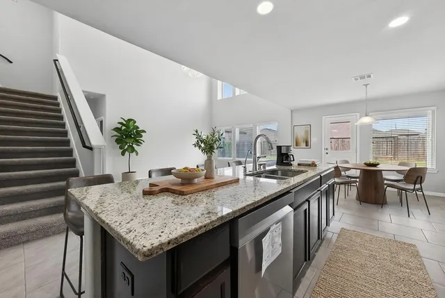 a kitchen with sink and stove