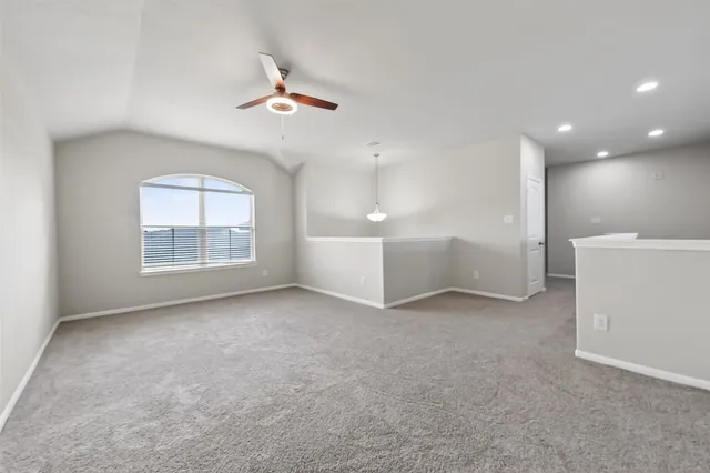 an empty room with windows and cabinet