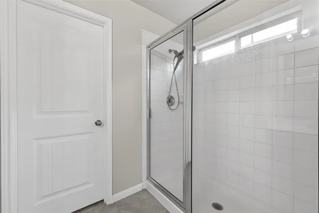 a bathroom with a glass shower door