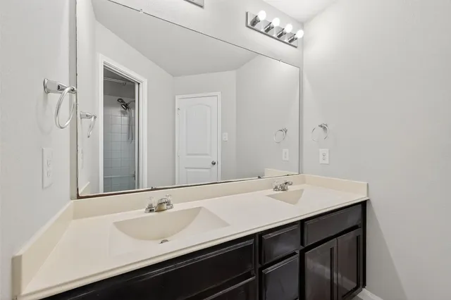 a bathroom with a sink vanity and a mirror