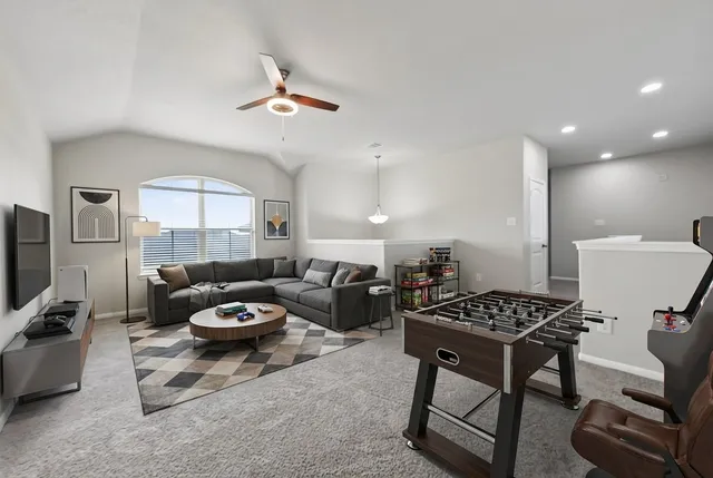 a living room with furniture a rug and a window