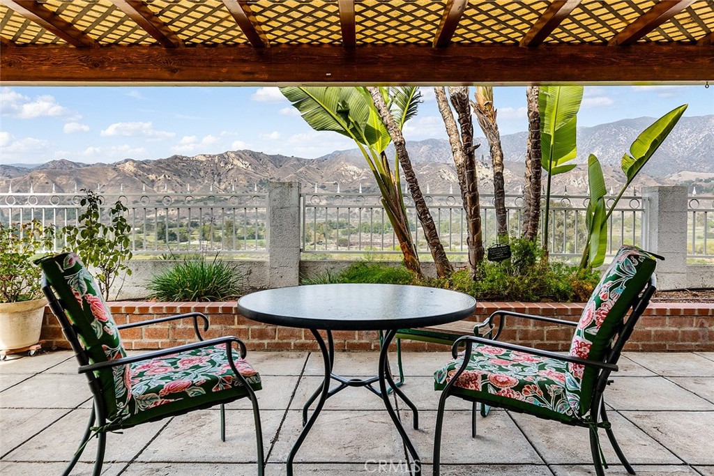 a view of a chairs and table in patio