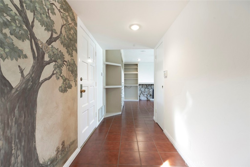 9071 Riderwood Drive Sunland, CA 91040 - Photo 11 of 46 a view of a hallway with wooden shelves