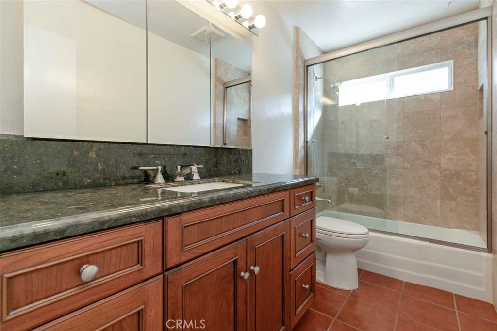 9071 Riderwood Drive Sunland, CA 91040 - Photo 18 of 46 a bathroom with a granite countertop sink a toilet and shower