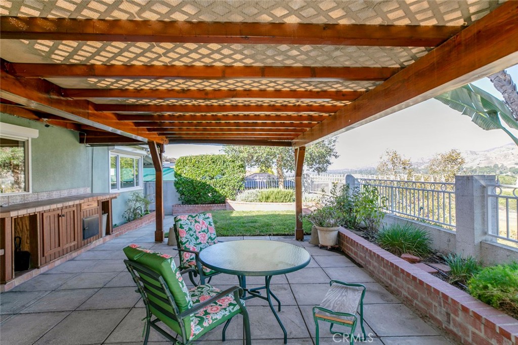 9071 Riderwood Drive Sunland, CA 91040 - Photo 22 of 46 a view of a patio with a table chairs and a table