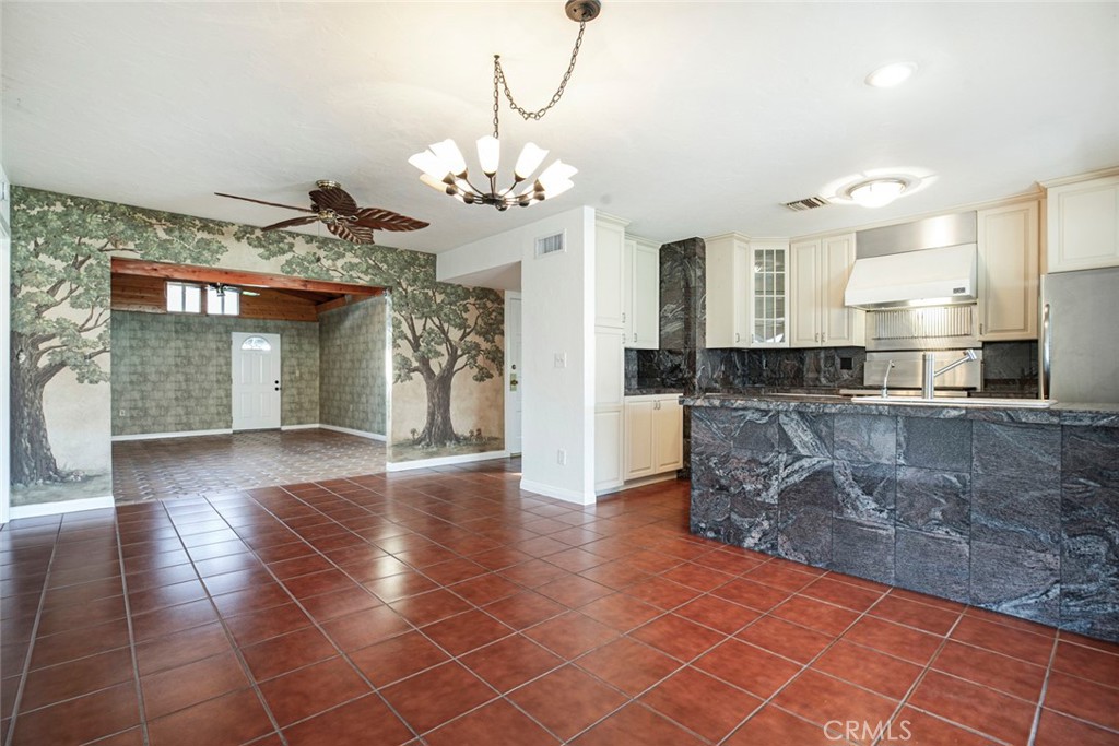 9071 Riderwood Drive Sunland, CA 91040 - Photo 4 of 46 a view of a kitchen with granite countertop a rug a stove a sink and a counter space