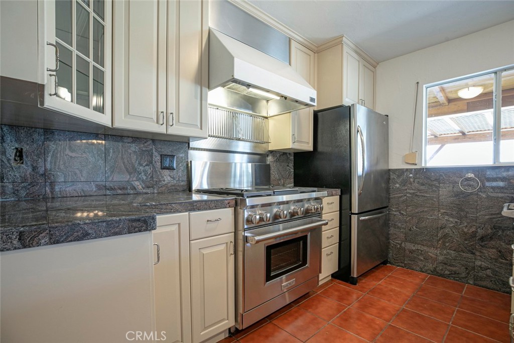 9071 Riderwood Drive Sunland, CA 91040 - Photo 8 of 46 a kitchen with stainless steel appliances granite countertop a stove a refrigerator and a microwave